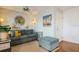 Living room features gray couch, ottoman, and coastal decor at 5005 Coquina Key Se Dr # E, St Petersburg, FL 33705