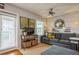 Living room with gray couch, TV, and access to balcony at 5005 Coquina Key Se Dr # E, St Petersburg, FL 33705