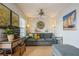 Living room with gray couch, coastal art, and ceiling fan at 5005 Coquina Key Se Dr # E, St Petersburg, FL 33705
