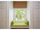Charming window seat with green cushions and built-in storage at 5005 Coquina Key Se Dr # E, St Petersburg, FL 33705