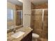 Bathroom with granite vanity, large mirror, and walk-in shower at 604 8Th Sw St, Ruskin, FL 33570