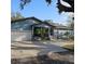 Ranch style home with attached garage, screened porch, and mature landscaping at 604 8Th Sw St, Ruskin, FL 33570