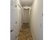 Long hallway with tile flooring and multiple doors at 604 8Th Sw St, Ruskin, FL 33570