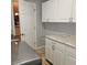 Laundry room with white cabinets, granite countertop and shelving at 604 8Th Sw St, Ruskin, FL 33570