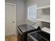 Bright laundry room, featuring washer, dryer, and shelving at 604 8Th Sw St, Ruskin, FL 33570