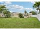 Landscaped backyard with green lawn and home view at 7698 Cardiff Ct, St Petersburg, FL 33709