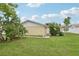 Landscaped backyard with lush green grass at 7698 Cardiff Ct, St Petersburg, FL 33709