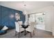 Open dining area with a glass table and four chairs, adjacent to a sunroom at 7698 Cardiff Ct, St Petersburg, FL 33709