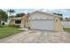Attractive home with a white garage door and American flag at 7698 Cardiff Ct, St Petersburg, FL 33709