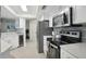 Updated kitchen featuring stainless steel appliances and white cabinetry at 7698 Cardiff Ct, St Petersburg, FL 33709
