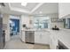 Modern kitchen with white cabinets, stainless steel appliances, and quartz countertops at 7698 Cardiff Ct, St Petersburg, FL 33709