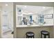 Modern kitchen features white cabinets, quartz countertops, and stainless steel appliances at 7698 Cardiff Ct, St Petersburg, FL 33709
