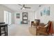 Living room features two armchairs, a media console, and tile flooring at 7698 Cardiff Ct, St Petersburg, FL 33709
