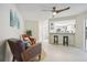 Bright living room with tile floors, comfy seating, and a ceiling fan at 7698 Cardiff Ct, St Petersburg, FL 33709