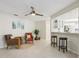 Bright living room with tile floors, comfy seating, and a ceiling fan at 7698 Cardiff Ct, St Petersburg, FL 33709