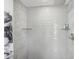 Modern shower with wave patterned tile and glass shelves at 7698 Cardiff Ct, St Petersburg, FL 33709