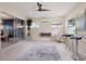 Sunroom with fireplace, glass sliders opening to dining area, and ceiling fan at 7698 Cardiff Ct, St Petersburg, FL 33709