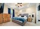 Main bedroom with a gray upholstered bed and wood dresser at 8332A Jackson Springs Rd, Tampa, FL 33615