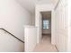 Upstairs hallway with carpet, doors to bedrooms, and a staircase at 8951 Walnut Gable Ct, Riverview, FL 33578