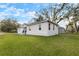 Side view of the house with a large yard and trees at 902 W Alsobrook St, Plant City, FL 33563