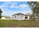 Rear view of the home with a patio and open space at 902 W Alsobrook St, Plant City, FL 33563