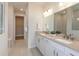 Double vanity bathroom with white cabinets, beige countertops, and a walk-in shower at 9409 Barnacle Ln, Parrish, FL 34219