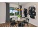 Bright dining room with round table and modern art at 9413 Barnacle Ln, Parrish, FL 34219