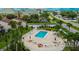 An aerial view showing a community pool, patio furniture, and surrounding landscape at 1028 Apollo Beach Blvd # 11, Apollo Beach, FL 33572