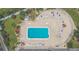 Aerial view of a community pool with surrounding lounge chairs and patio tables at 1028 Apollo Beach Blvd # 11, Apollo Beach, FL 33572