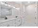 Elegant bathroom with double vanity, white cabinets, and quartz countertops at 112 Sidney Ct, Rotonda West, FL 33947