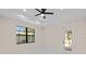 Spacious bedroom with ceiling fan, large window, and access to the backyard at 112 Sidney Ct, Rotonda West, FL 33947