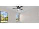 Bedroom with two large windows and a ceiling fan at 112 Sidney Ct, Rotonda West, FL 33947