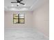 Bright bedroom with a ceiling fan and large window, showcasing natural light at 112 Sidney Ct, Rotonda West, FL 33947