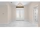 Bright and spacious entryway with double doors and marble-look flooring at 112 Sidney Ct, Rotonda West, FL 33947