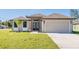 New construction home with a two-car garage and attractive landscaping at 112 Sidney Ct, Rotonda West, FL 33947