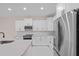White kitchen with stainless steel appliances and expansive countertops at 112 Sidney Ct, Rotonda West, FL 33947