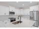Modern kitchen island with a large quartz countertop and stainless steel sink at 112 Sidney Ct, Rotonda West, FL 33947