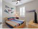 Bedroom with striped bedding and various sports memorabilia at 11522 Fountainhead Dr, Tampa, FL 33626