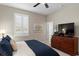Spacious bedroom with dresser, TV, and ceiling fan at 11522 Fountainhead Dr, Tampa, FL 33626