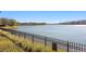 Ornamental iron fence along the lake, offering privacy and security at 11522 Fountainhead Dr, Tampa, FL 33626