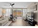 Spacious living area with hardwood floors, a sofa, and a large TV at 11522 Fountainhead Dr, Tampa, FL 33626