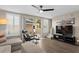 Living area with hardwood floors, sliding doors to patio, and sectional sofa at 11522 Fountainhead Dr, Tampa, FL 33626