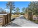 Long gravel driveway leading to a two-story house at 14450 Lancer Rd, Spring Hill, FL 34610