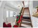Entryway with staircase and holiday decor at 14450 Lancer Rd, Spring Hill, FL 34610