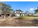 Back of house with large yard, shed, and covered patio at 14450 Lancer Rd, Spring Hill, FL 34610