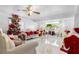 Bright living room with elegant furniture, Christmas tree, and large window at 14450 Lancer Rd, Spring Hill, FL 34610