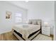 Bright bedroom with queen-size bed and neutral decor at 14469 Bulger Ave, Port Charlotte, FL 33953