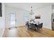 Bright dining room features a chandelier and gray chairs at 14469 Bulger Ave, Port Charlotte, FL 33953