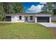 New construction home with gray accents and a two-car garage at 14469 Bulger Ave, Port Charlotte, FL 33953