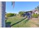 Landscaped backyard with lush greenery and screened patio at 1526 Leland Dr # 1525, Sun City Center, FL 33573